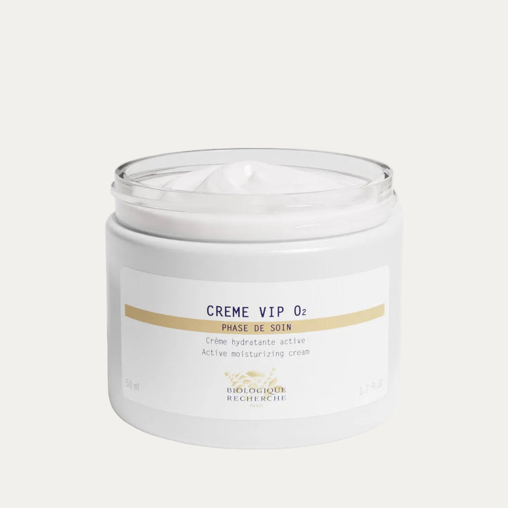 Opened white glass jar 50ml labeled 'Crème VIP O2', oxygenating face cream on a white background, Biologique Recherche at Oasis Amsterdam