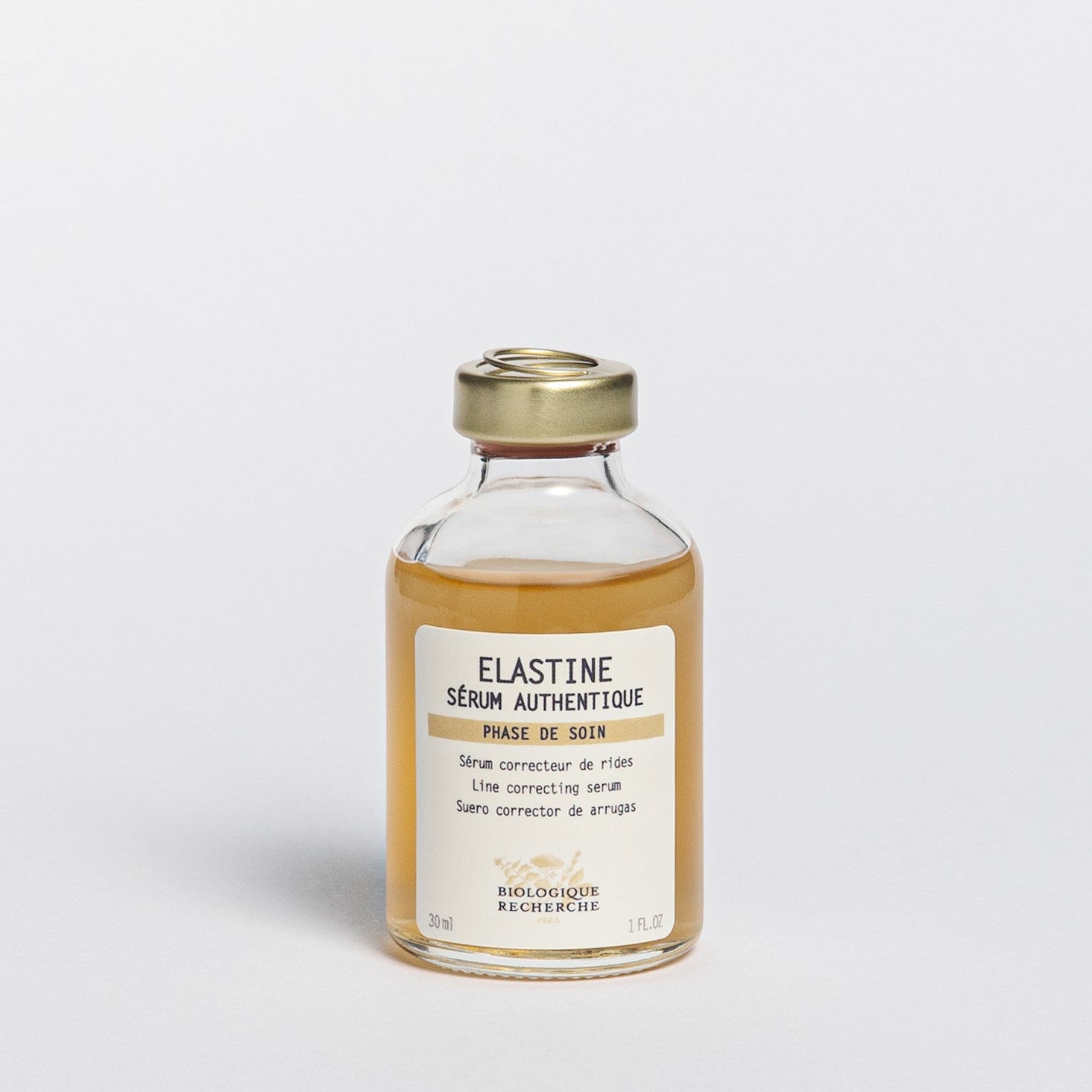 Glass serum bottle labeled 'Elastine Serum Authentique', Line correcting serum, on a white background, BR Amsterdam