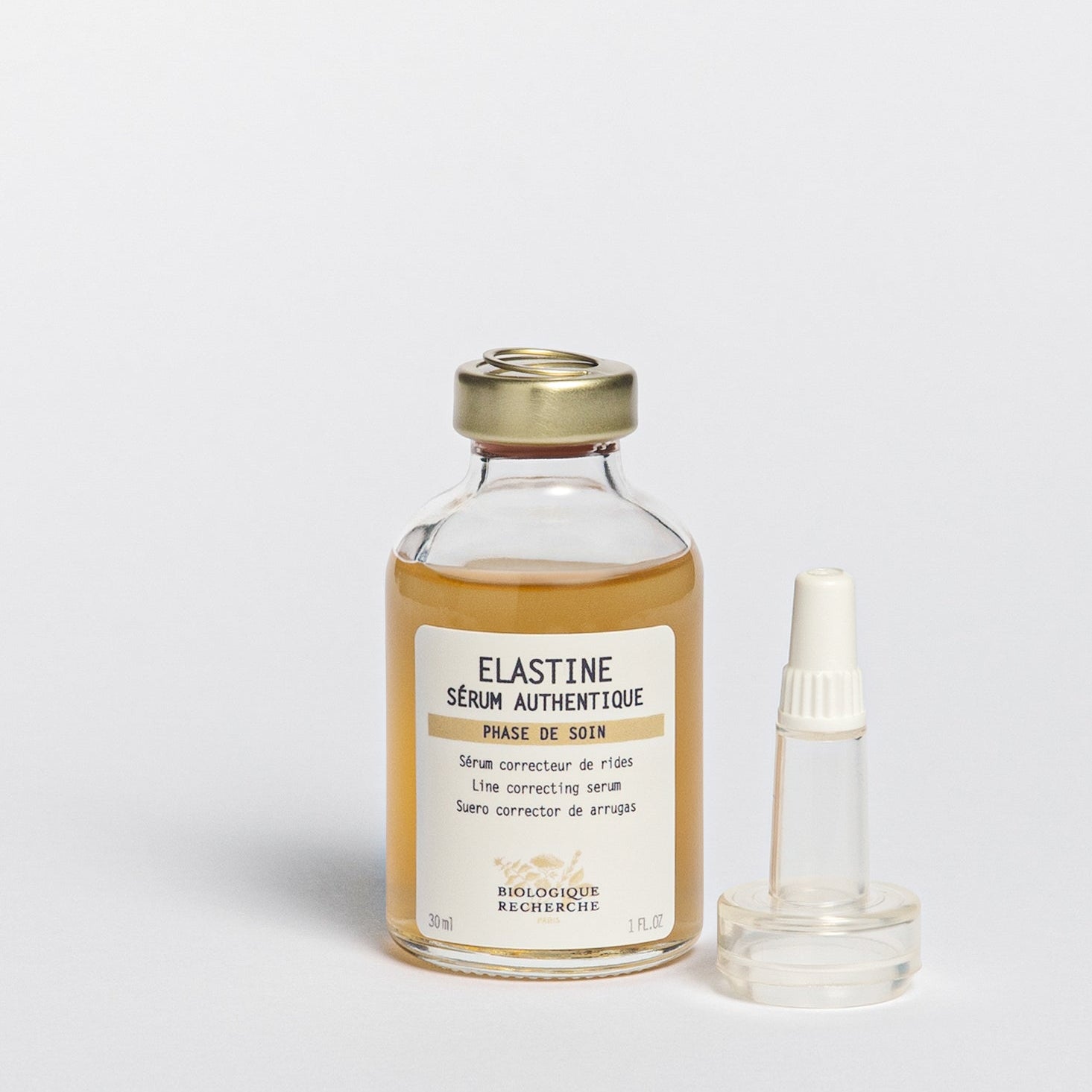 Glass serum closed bottle 30ml with pipette, labeled 'Elastine Serum Authentique', Line correcting serum, on a white background, BR Amsterdam