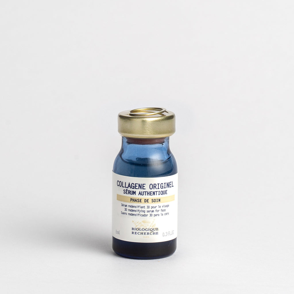 Bottle of 'Collagène Originel' serum with a gold cap on a light gray background 8ml